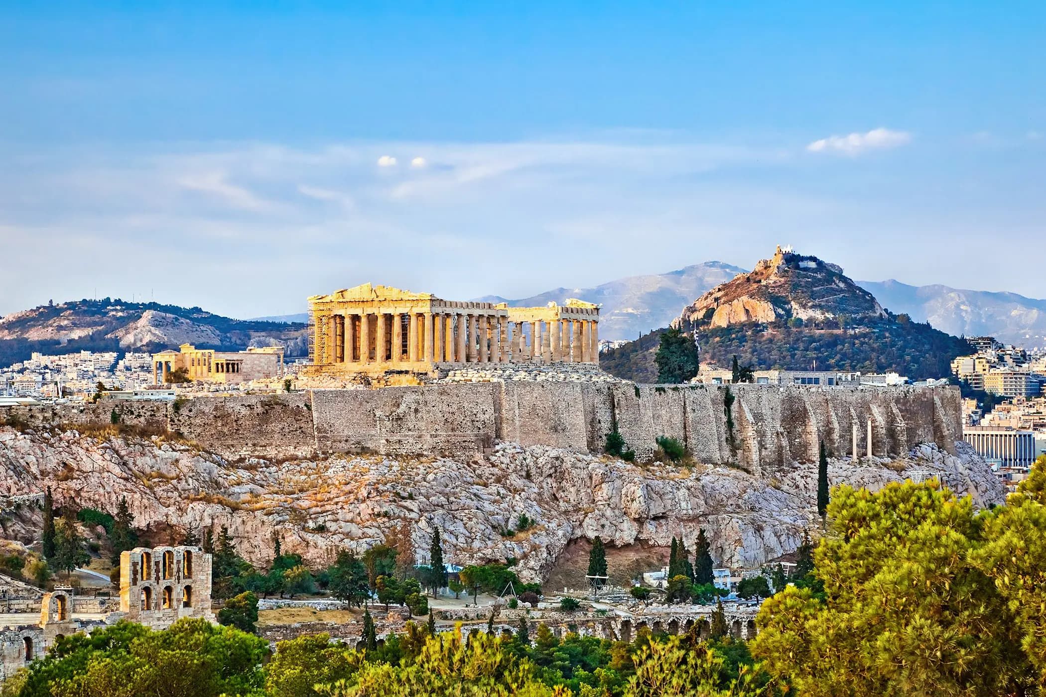 The Parthenon on the Acropolis above Athens, with Mount Lycabettus rising behind the city